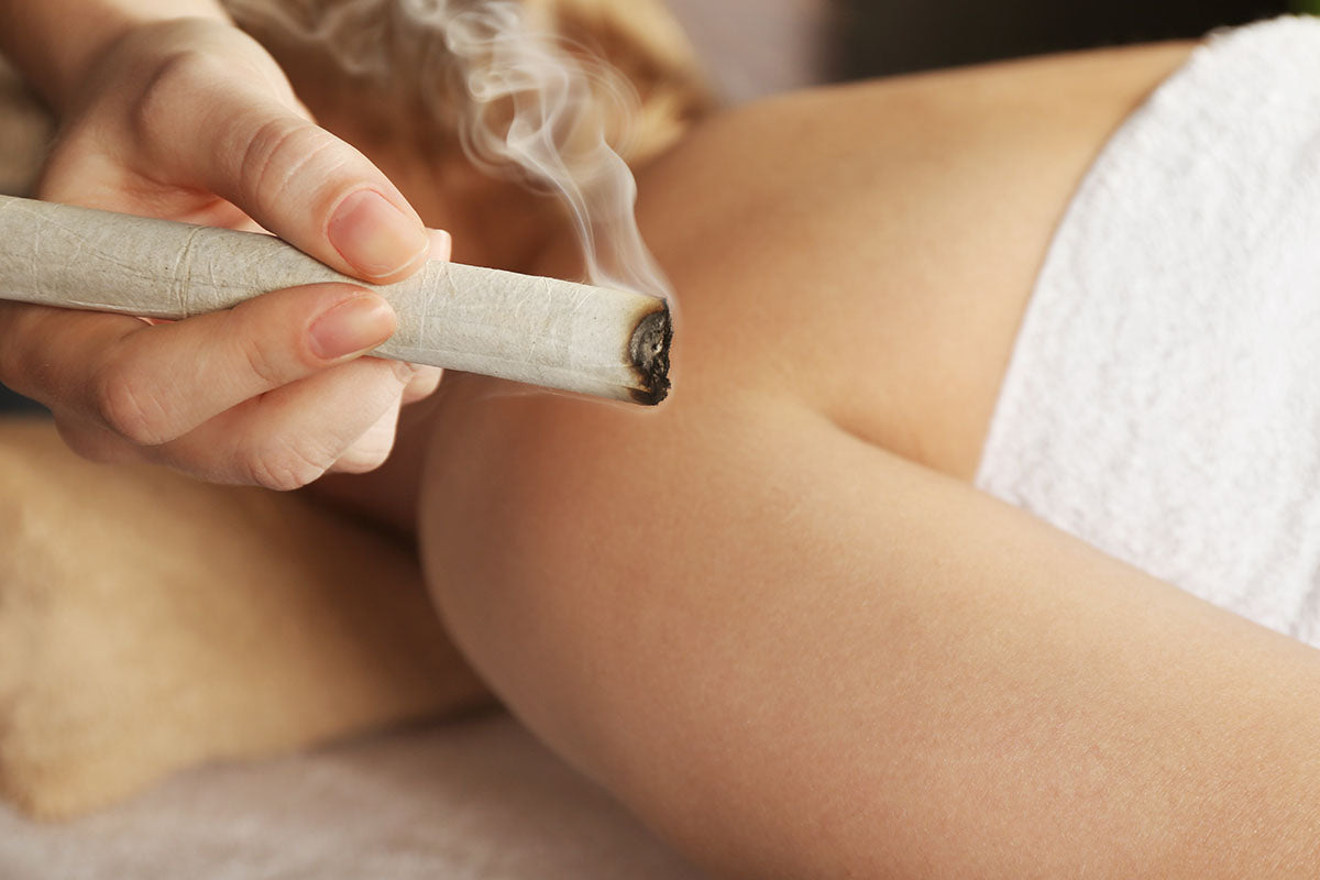 Burning moxa stick being used to perform moxibustion