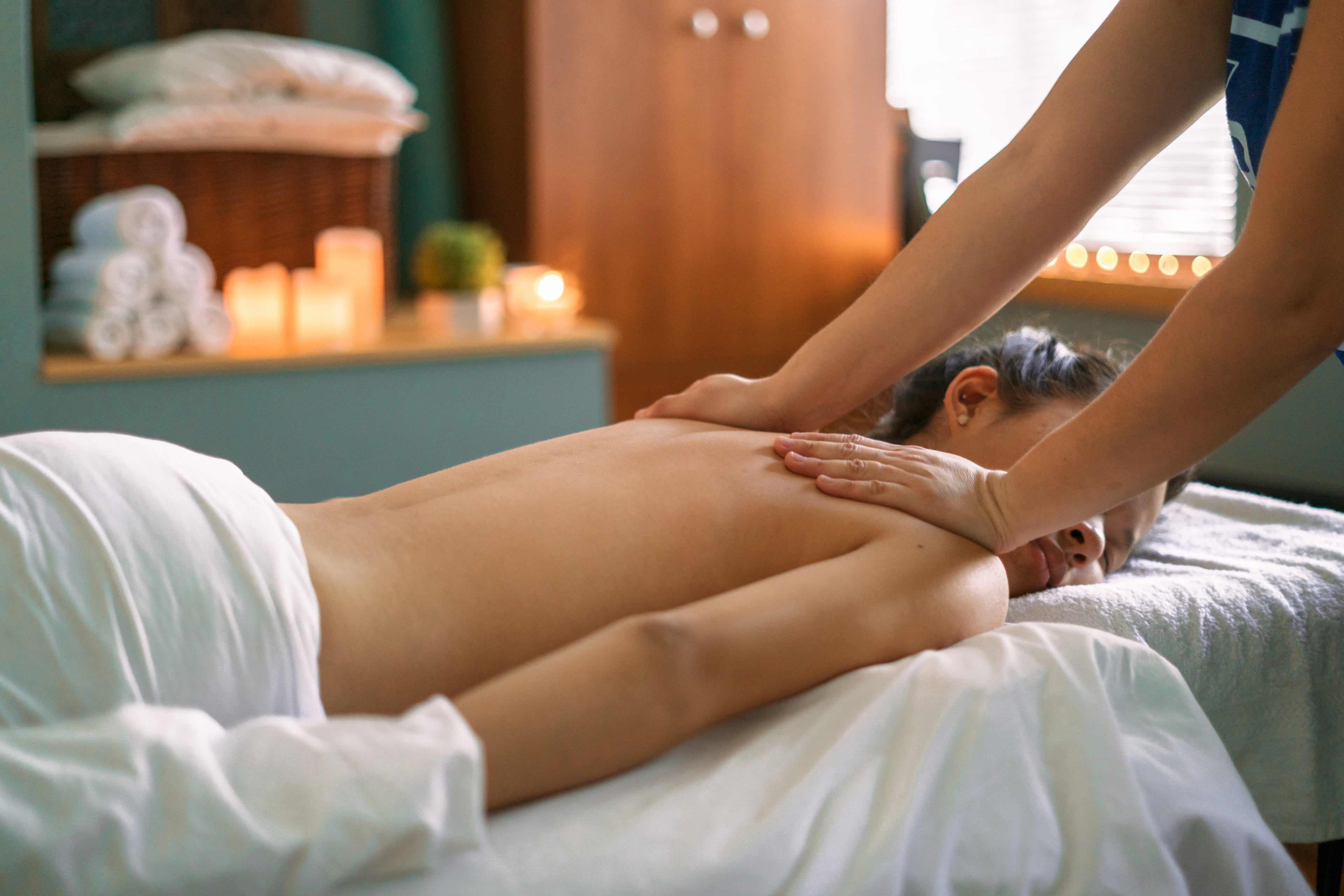 Woman receiving relaxing upper body massage.